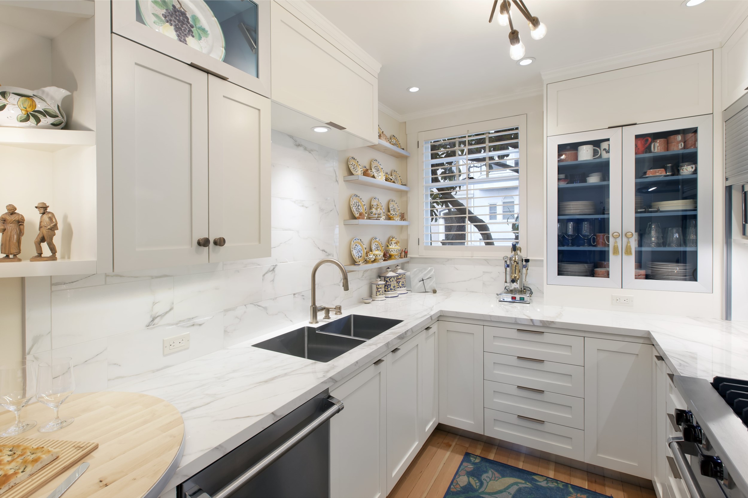 Kitchen with porcelain slab countertop and tile backsplash