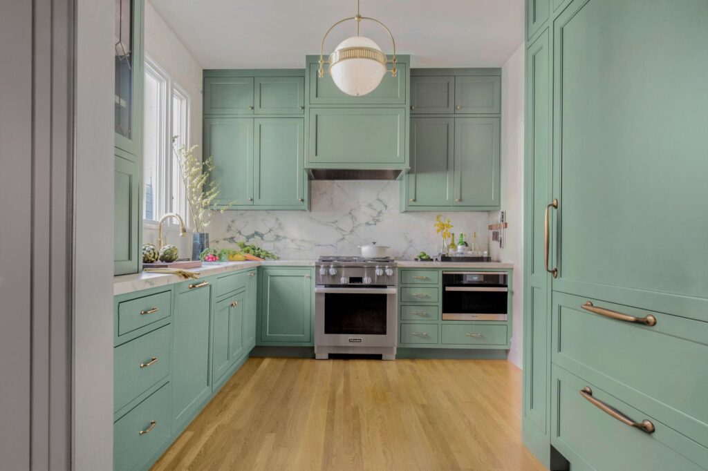 kitchen featuring smoke green cabinets and breccia capraia marble backsplash