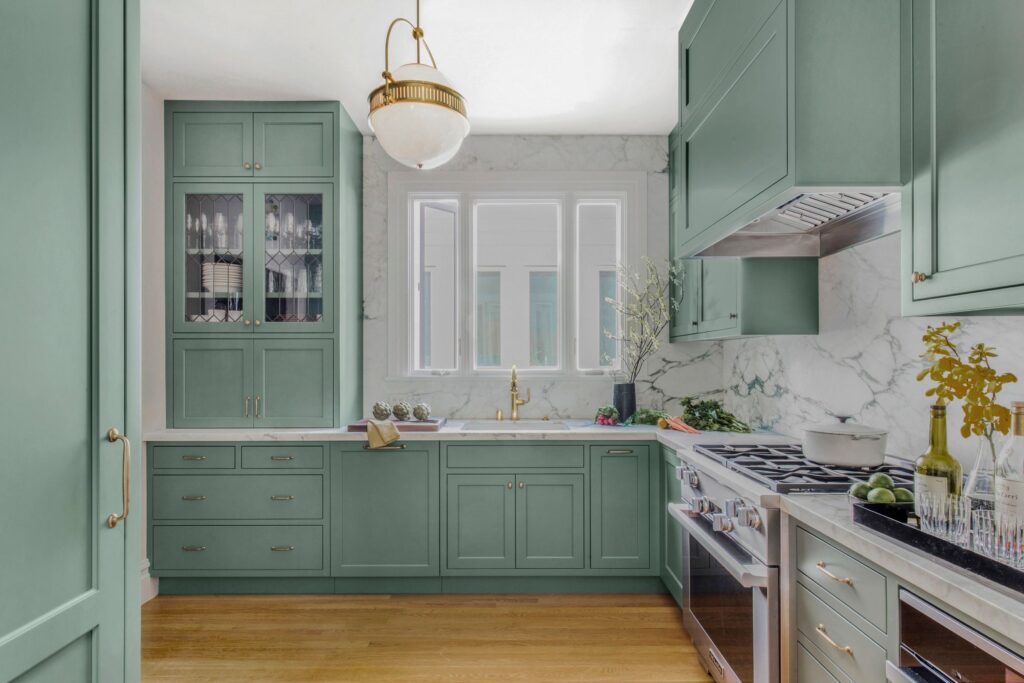 kitchen with smoke green cabinets and breccia capraia marble countertops