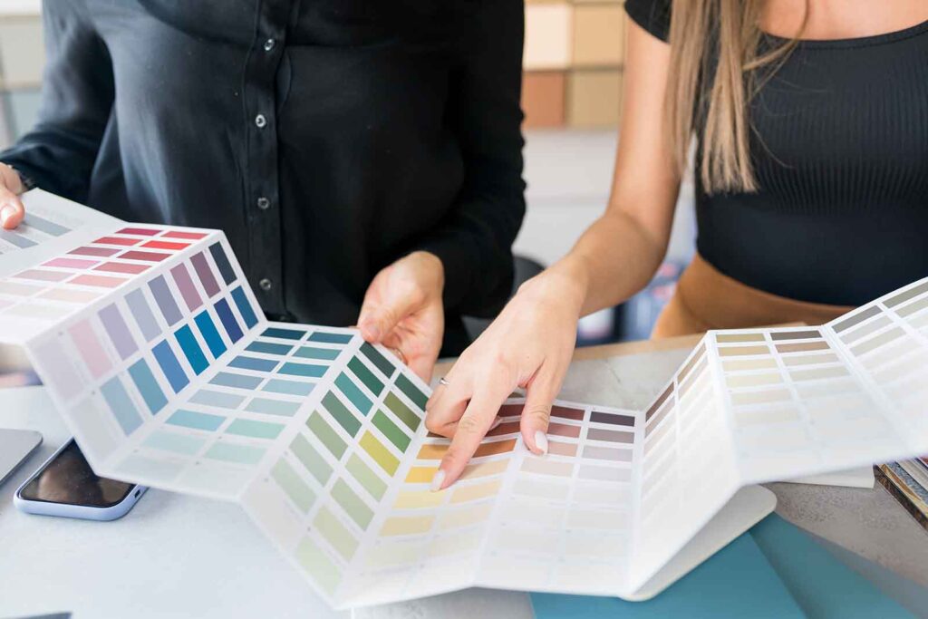 Preparing for home design by choosing color swatches.