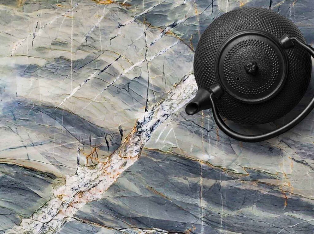 Ijen Blue Quartzite demonstrates heat resistance with teapot on counter.