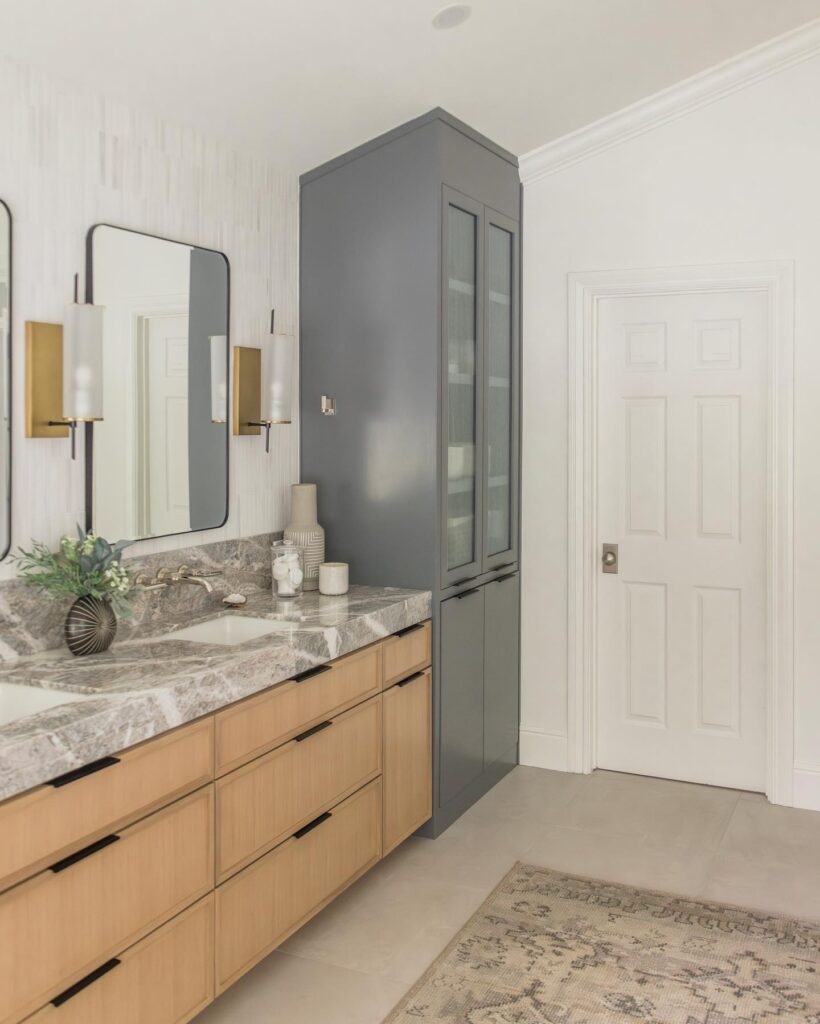 Figure 1A neutral color palette lightens up the space and draws attention to the fixtures and the bold veins of the Fior De Pesco Marble countertop