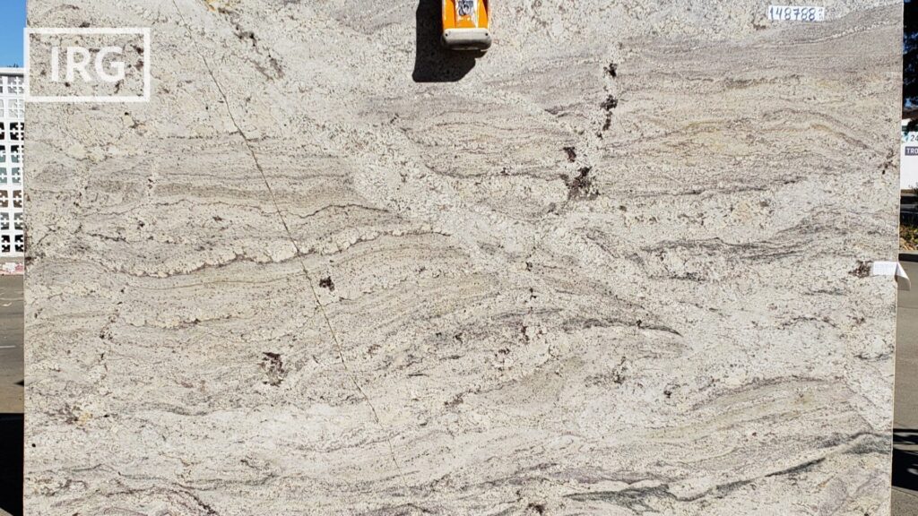 Azul Bahia granite slab from IRG in the Brisbane, CA warehouse, featuring deep blue tones with white, black, and brown accents, perfect for luxury kitchen countertops.