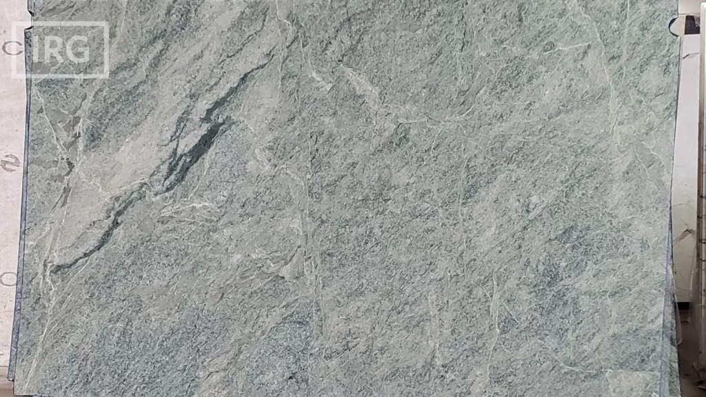 Costa Esmeralda granite slab from IRG in the Dublin, CA showroom, featuring a green background with creamy veins, perfect for adding an earthy vibe to kitchen designs.