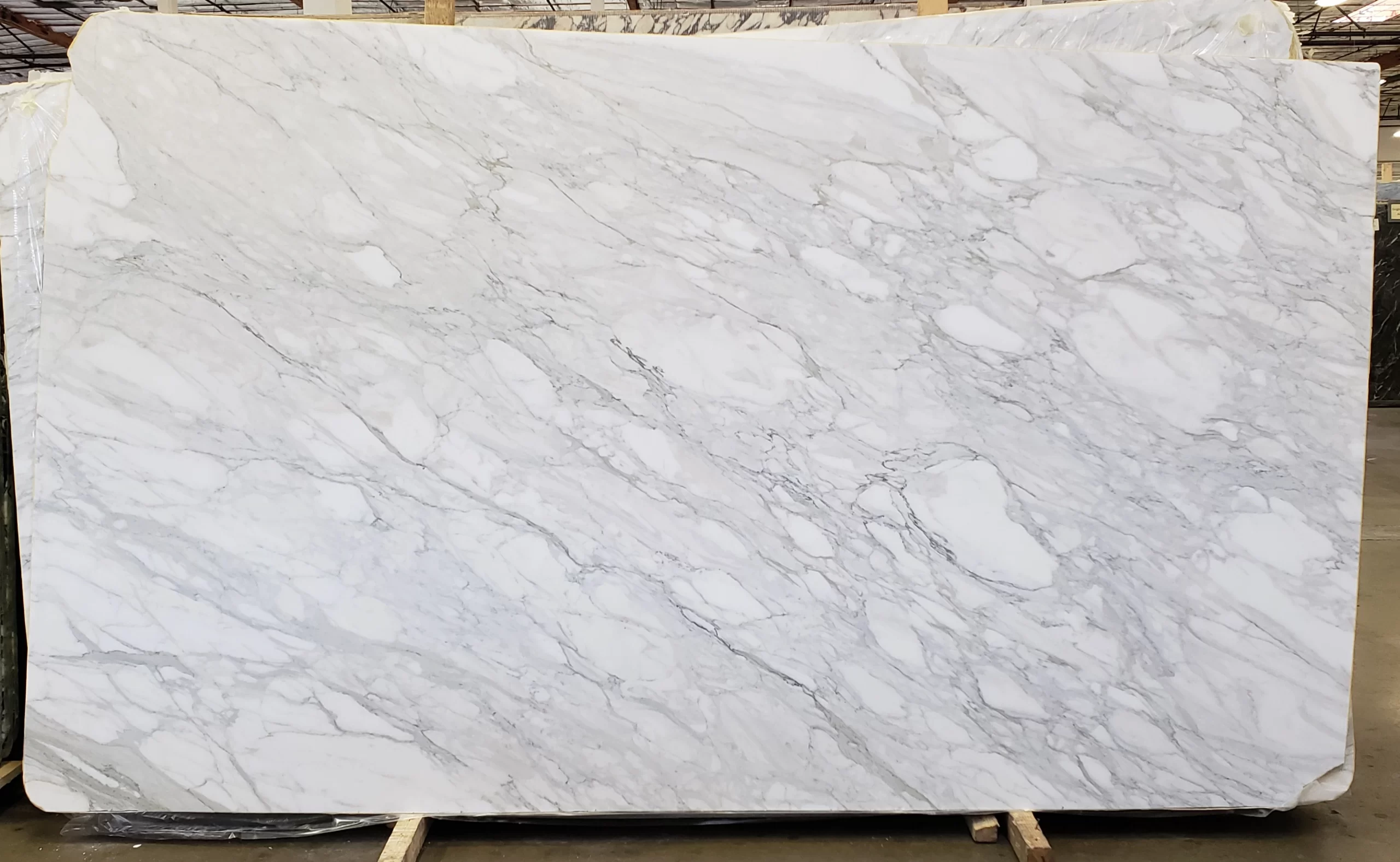 Calacatta Delicato marble slab with dual finishes, honed and polished, ideal for luxury Bay Area kitchens or Sacramento showers.